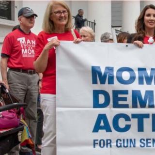 Women holding Moms Demand Action banner