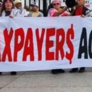 People holding Taxpayers Aganst Genocide banner