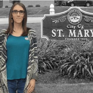 Woman standing next to St. Mary's sign