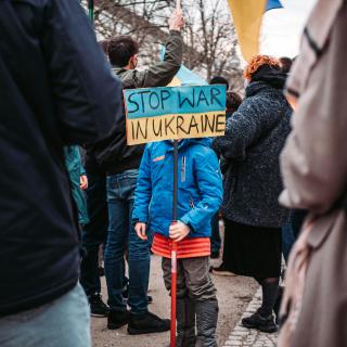 Child with sign Stop War in Ukraine