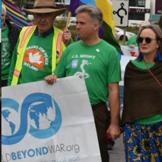 David Swanson marching with World Beyond War banner