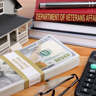 Money, house, book titled Dept of Veterans Affairs