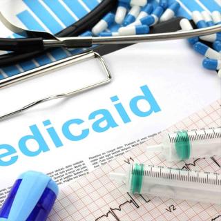 Syringes and pills and word Medicaid