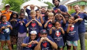 Kids making heart signs with their hands