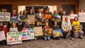 People posing with signs